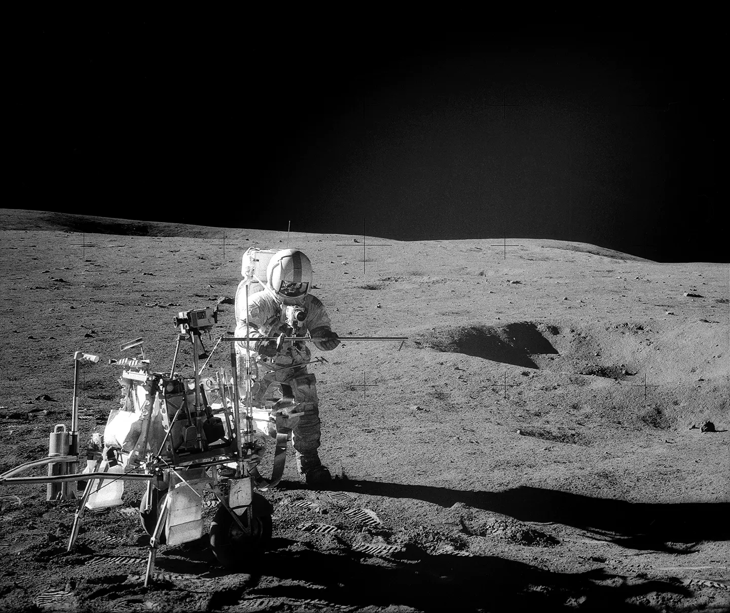 a black and white photograph of an astronaut on the surface of the moon